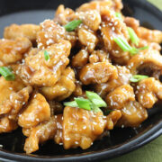 Oyster sauce chicken topped with sesame seeds and green onions