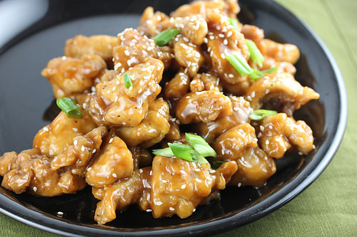 Oyster sauce chicken topped with sesame seeds and green onions