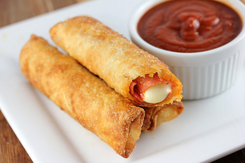 Fried pizza sticks with melted cheese and marinara sauce