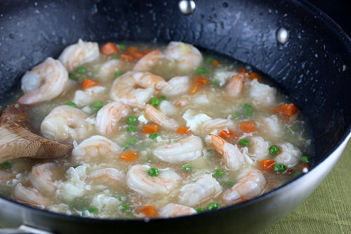 Shrimp cooking with vegetables in a skillet