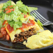 Taco omelet topped with salsa, lettuce, and diced tomatoes