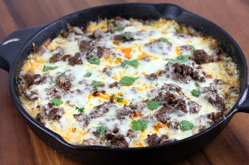 Close up of cheesy tamale pie with browned beef and cilantro