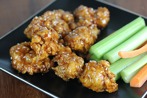 Teriyaki boneless wings served with celery and carrot sticks