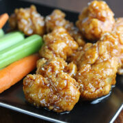 Teriyaki boneless wings served with celery and carrot sticks