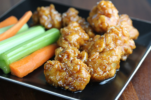 Teriyaki boneless wings served with celery and carrot sticks