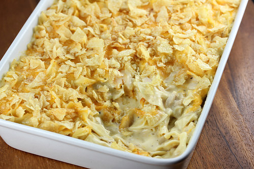 Baking dish filled with tuna casserole covered in golden potato chips