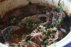 Shredded beef cooking in slow cooker