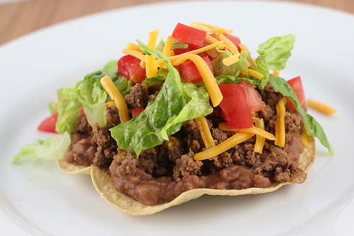 Crispy beef tostada with lettuce