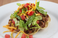 Loaded beef tostada on plate