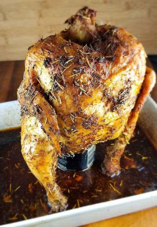 Seasoned beer can chicken standing upright