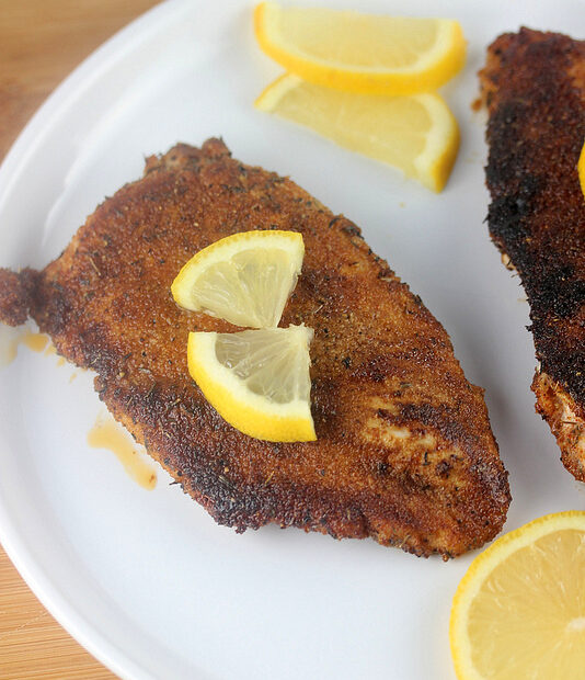 Blackened chicken breast with lemon slices