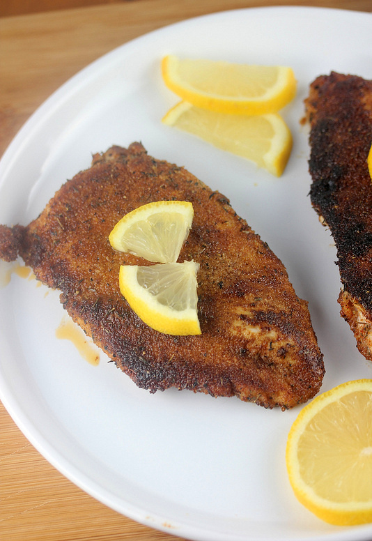 Blackened chicken breast with lemon slices