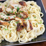 Blackened chicken over creamy Alfredo pasta