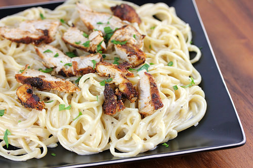 Blackened chicken over creamy Alfredo pasta