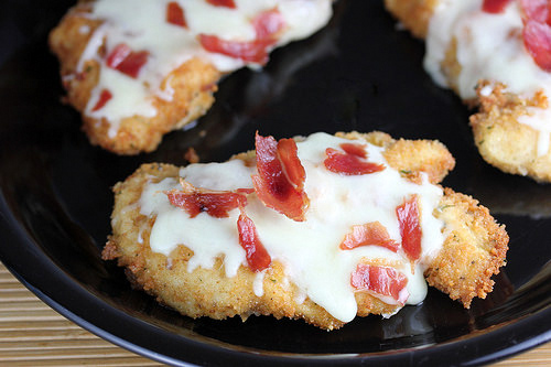 Breaded chicken topped with melted cheese and bacon