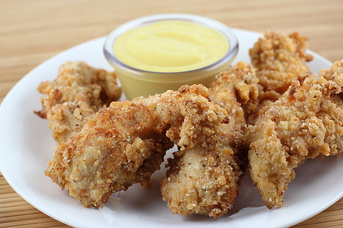 Plate of crispy chicken tenders with dipping sauce