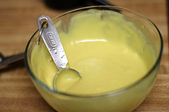 Bowl of dipping sauce with measuring spoon