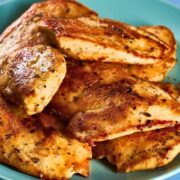 Unbreaded seasoned chicken tenderloins on a plate