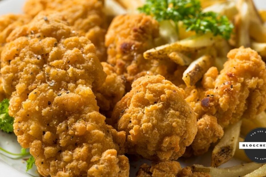 Baked chicken tenders with crispy coating and parsley garnish