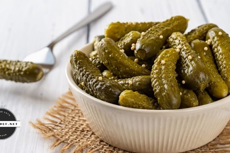 Bowl of cornichons on a wooden surface with text overlay