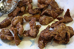 Crispy fried beef pieces draining on paper