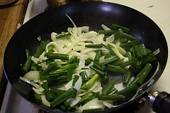 Onions and scallions sautéing in frying pan