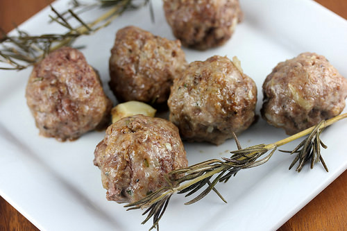 roast garlic meatballs with rosemary on a plate