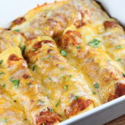 Baked pan of cheesy shredded beef enchiladas