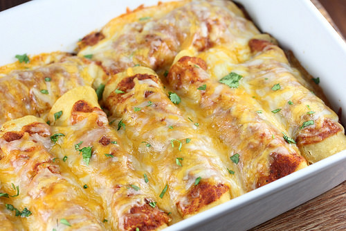 Baked pan of cheesy shredded beef enchiladas