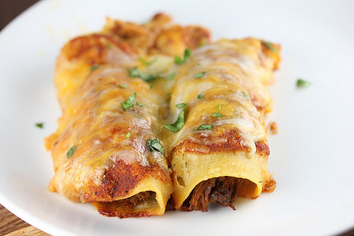 Cheesy beef enchiladas on a plate