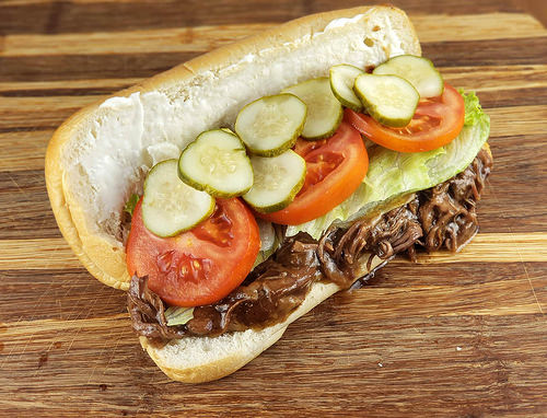 Beef po’ boy sandwich with toppings