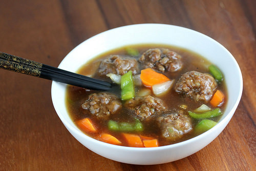 Bowl of beef meatball soup with vegetables