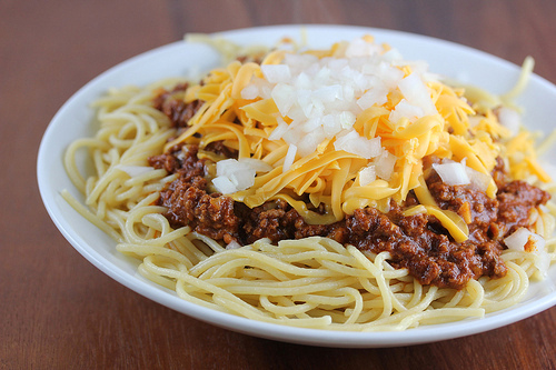 Spaghetti topped with Cincinnati chili, shredded cheese, and diced onions
