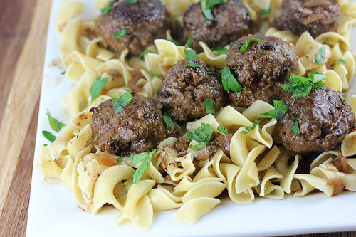 French-style meatballs with egg noodles, topped with parsley