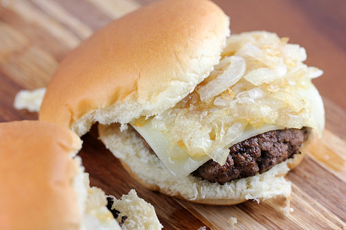 Grilled onion cheddar burger slider on soft bun