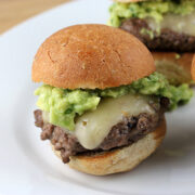 Cheesy sliders topped with fresh guacamole