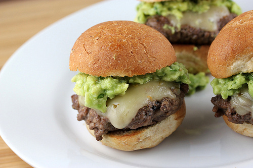 Cheesy sliders topped with fresh guacamole