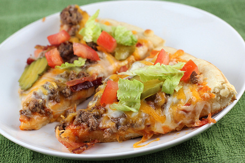 Cheeseburger pizza slices with toppings