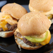 Cheeseburger sliders with melted cheese, pickles, and sauce
