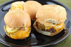 Cheeseburger sliders with melted cheese and sauce on soft buns