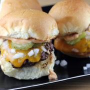 Cheeseburger sliders topped with pickles and onions