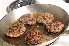 Cooking hamburger patties in a pan