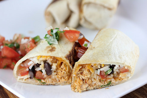 Sliced chicken burrito with fresh salsa