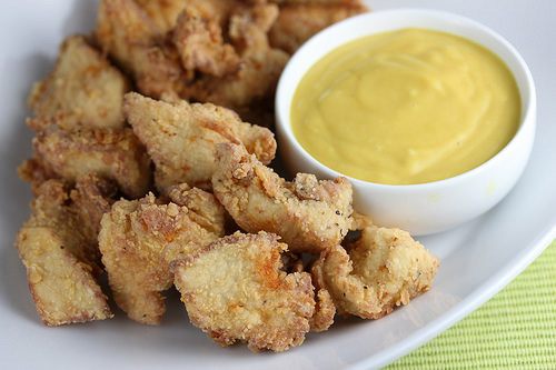 Plate of crispy chicken nuggets with sauce