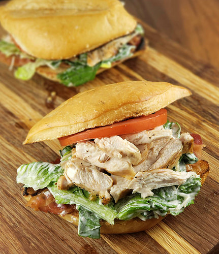 Chicken caesar sandwich on cutting board
