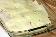 Swiss cheese slices in a baking dish