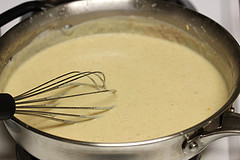Whisking creamy sauce in a pan