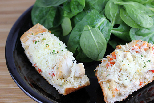 Chicken french bread pizza topped with shredded chicken and cheese