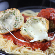 Chicken parmesan meatballs served over spaghetti with marinara