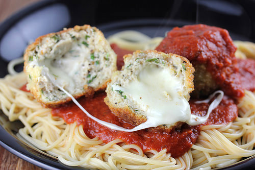 Chicken parmesan meatballs served over spaghetti with marinara